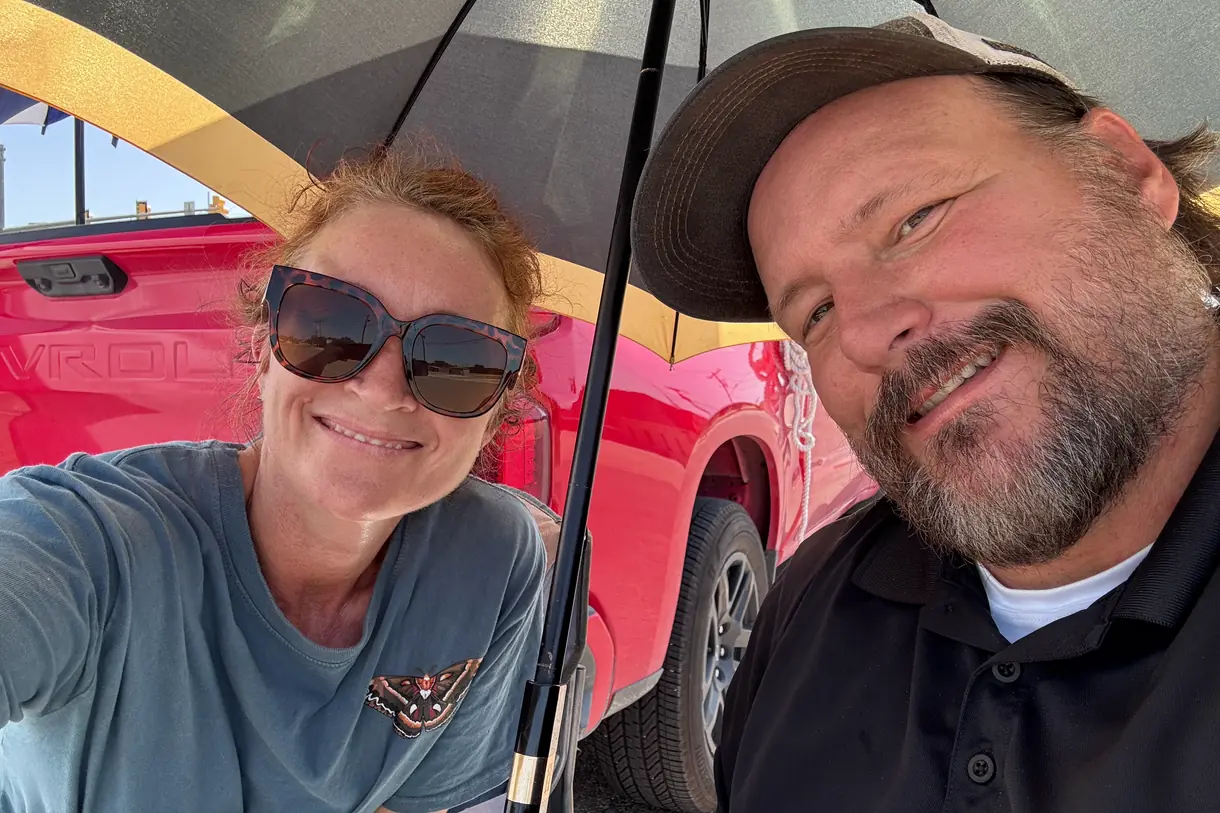 Wayne and Rhonda Smith together under an umbrella at an outdoor Seek the City outreach.